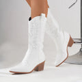 White women's Western cowboy knight boots with mid heel, pointed toe, microfiber upper, and rubber sole