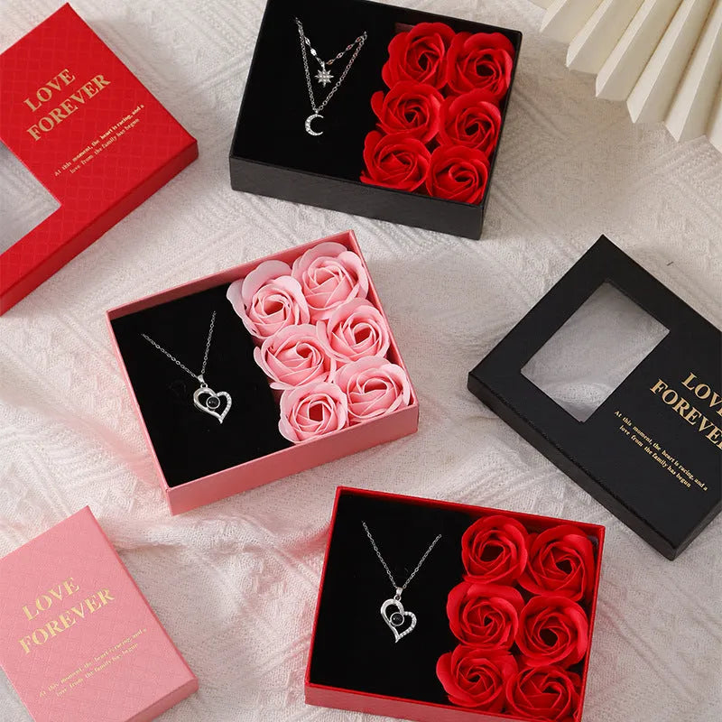 Red Korean-style gift box open to show six sculpted soap roses, with a matching handbag beside it.