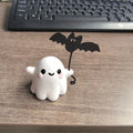 Mini resin statue of a white ghost walking a black bat, Halloween decoration