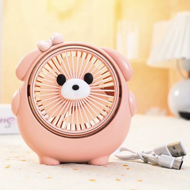 Small plastic desktop fan with a cute dog design, showing USB port and control buttons.
