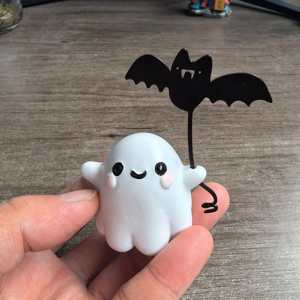 Mini resin statue of a white ghost walking a black bat, Halloween decoration