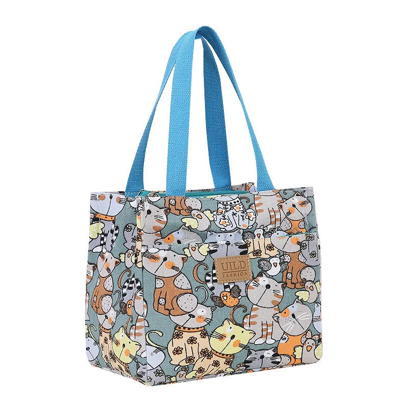 Women's printed floral canvas tote bag with aluminium frame open, showing large interior.