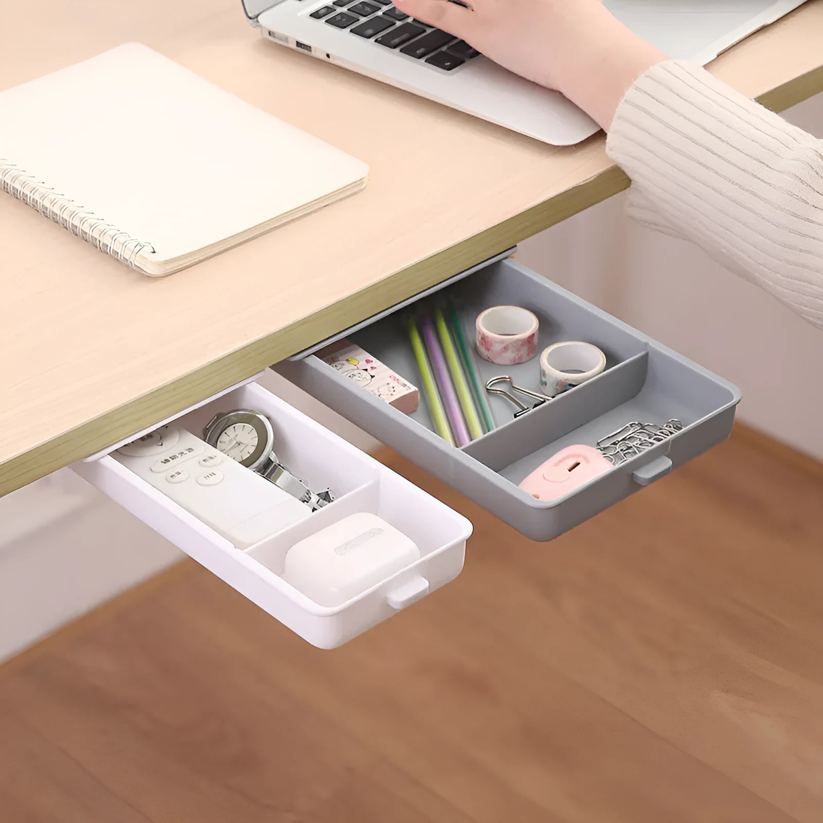 White plastic storage drawer with a cover and internal grid compartments, shown mounted underneath a wooden table.