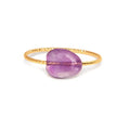 Original geometric design women's ring in coloured agate stone on a plain background.