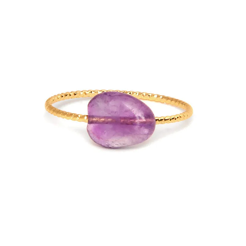 Original geometric design women's ring in coloured agate stone on a plain background.