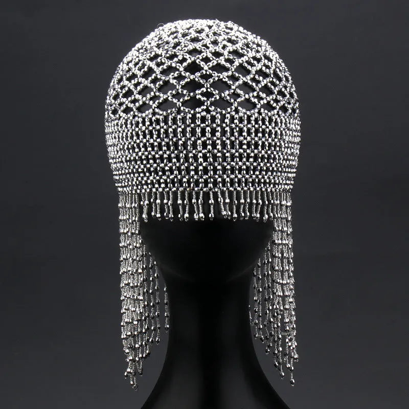 Silver belly dance hat with beaded tassels on black background for performance hair ornament