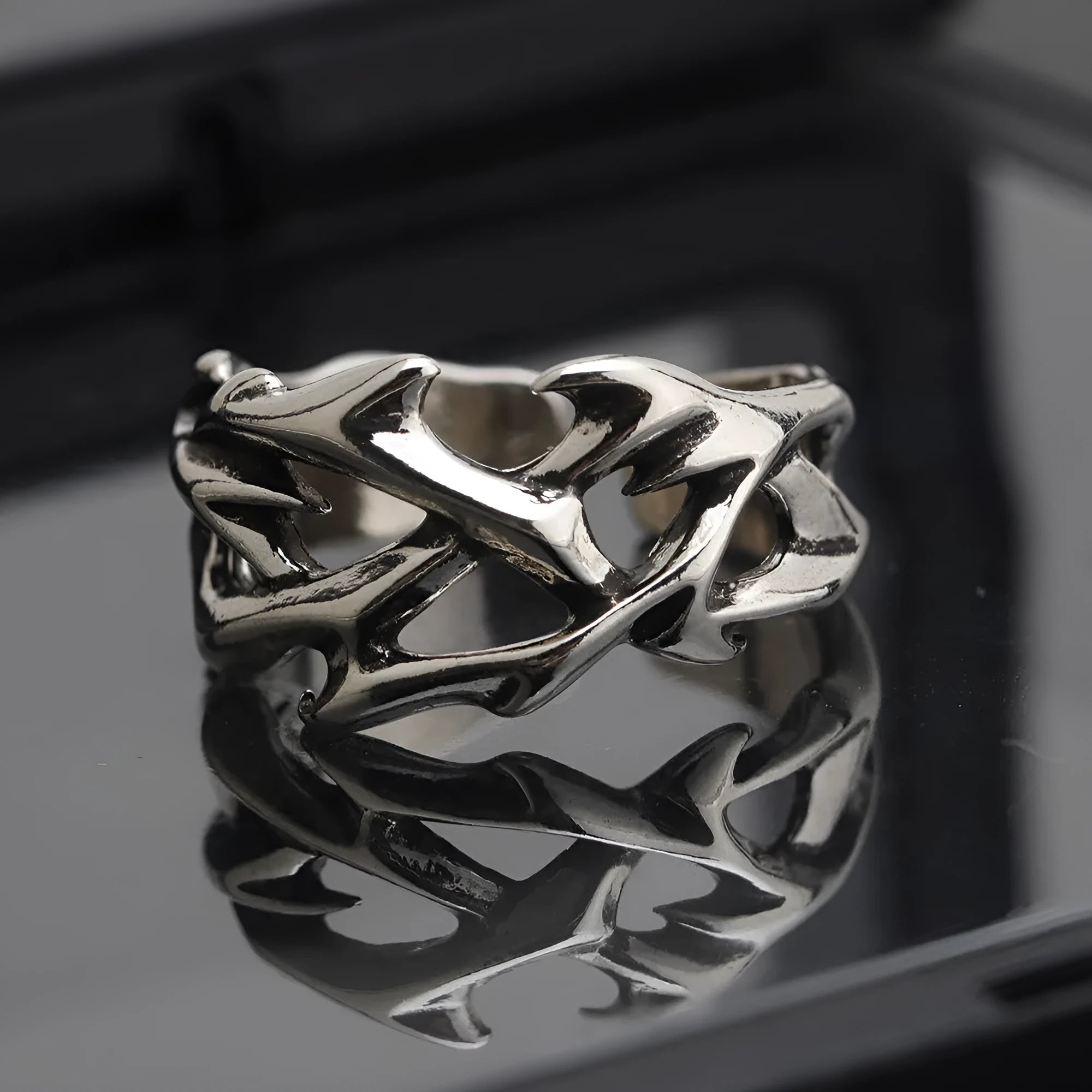 Copper men's ring with geometric thorn and flower design and adjustable band.