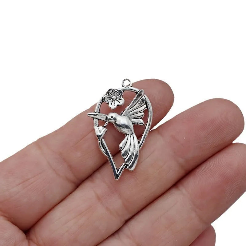 Gold-tone alloy magpie pendant charm for DIY jewellery making on a white background.