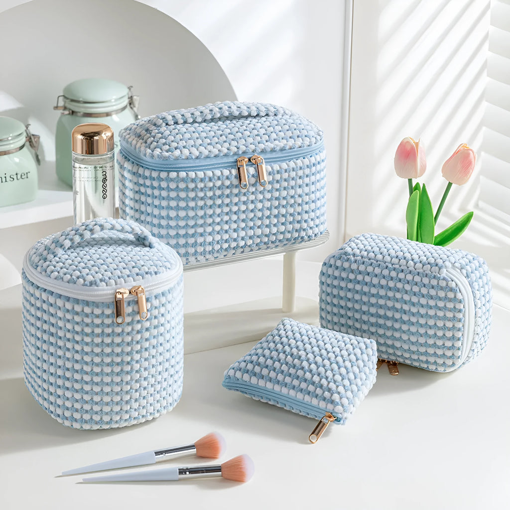 Four cube-shaped flannelette makeup bags in different colours: pink, khaki, pink dots, and blue with dots.