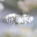 White alloy peach heart-shaped women's ring with floral and ocean opal detailing.