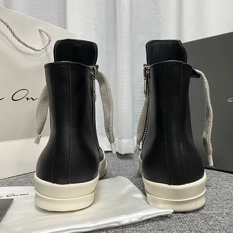 Black leather high-top sneakers with side zipper and round toe on a rubber platform sole