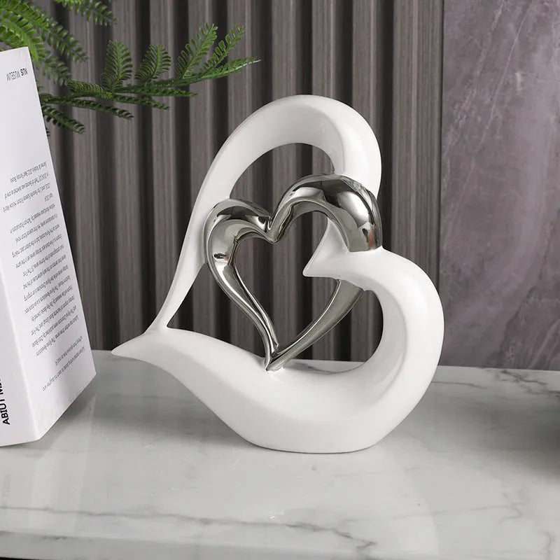 Modern geometric heart ornament in metallic finish displayed on shelf