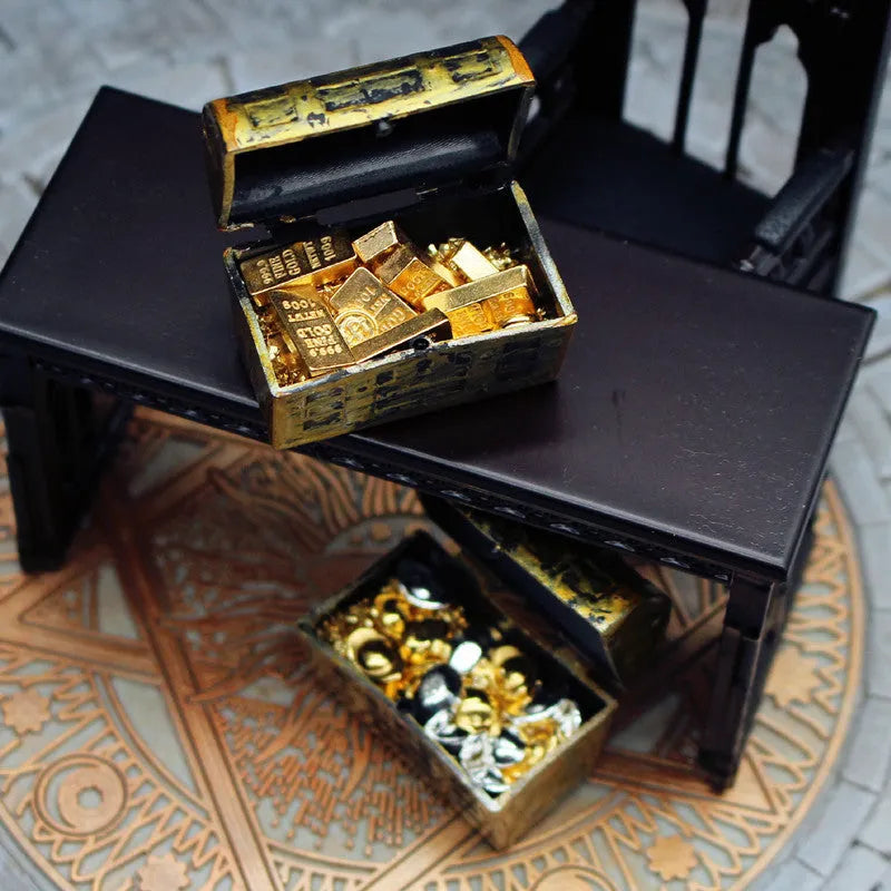 Alloy gold coin and bar treasure chest miniature doll house accessory on display.