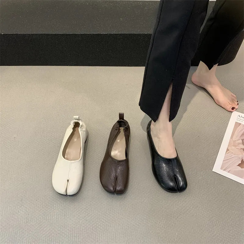 Women's apricot coloured chunky heel pumps with split toe horseshoe detail and round toe.