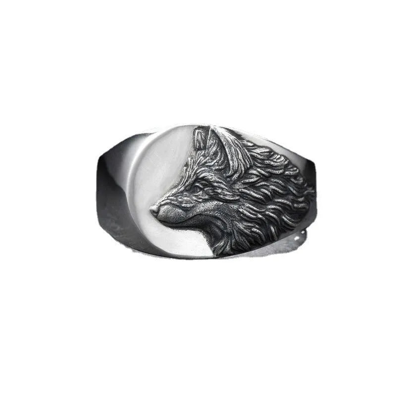 Men's silver alloy ring with a geometric domineering wolf design on a grey background.