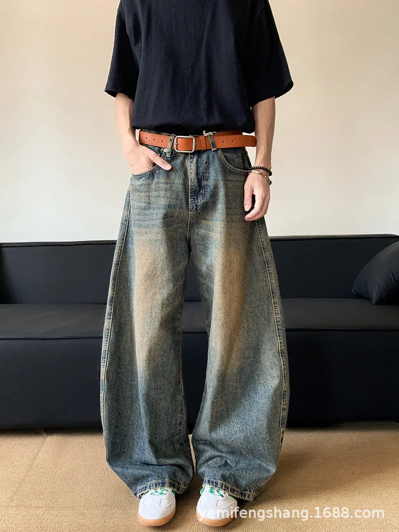 Man wearing Retro Blue distressed wide-leg denim jeans with a slimming silhouette and mid-waist fit.