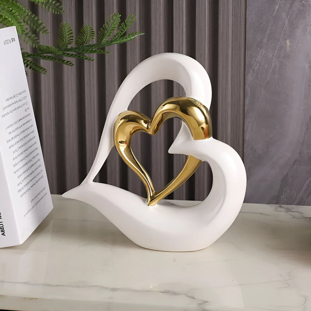 Modern geometric heart ornament in metallic finish displayed on shelf