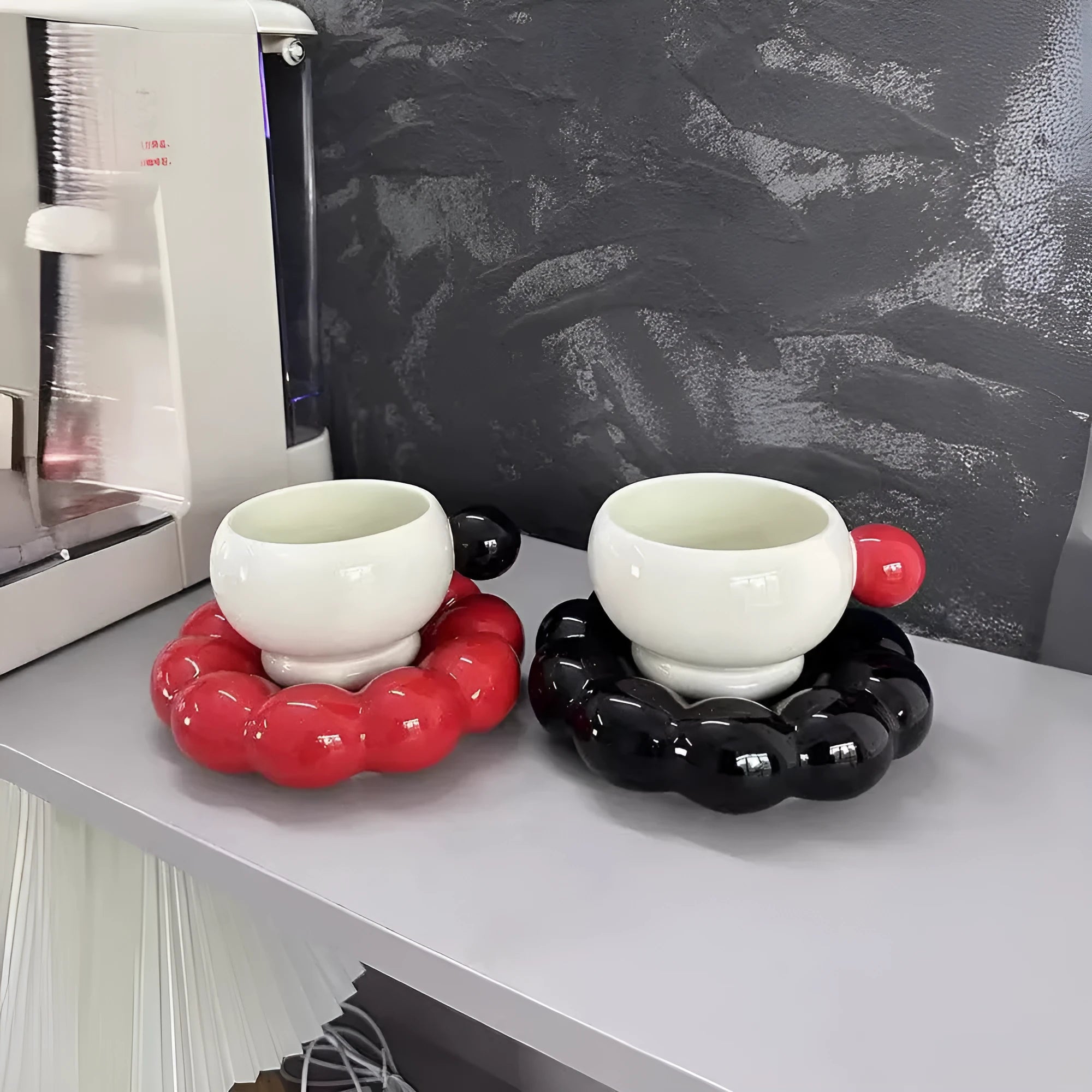 Ceramic coffee cup and saucer set in a simple Nordic design, shown in a choice of colours.