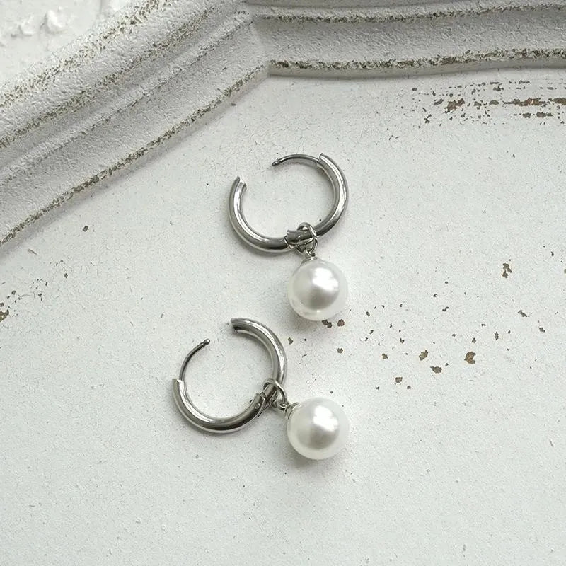 Geometric pearl hoop earrings with circular design and titanium steel alloy construction