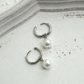 Geometric pearl hoop earrings with circular design and titanium steel alloy construction