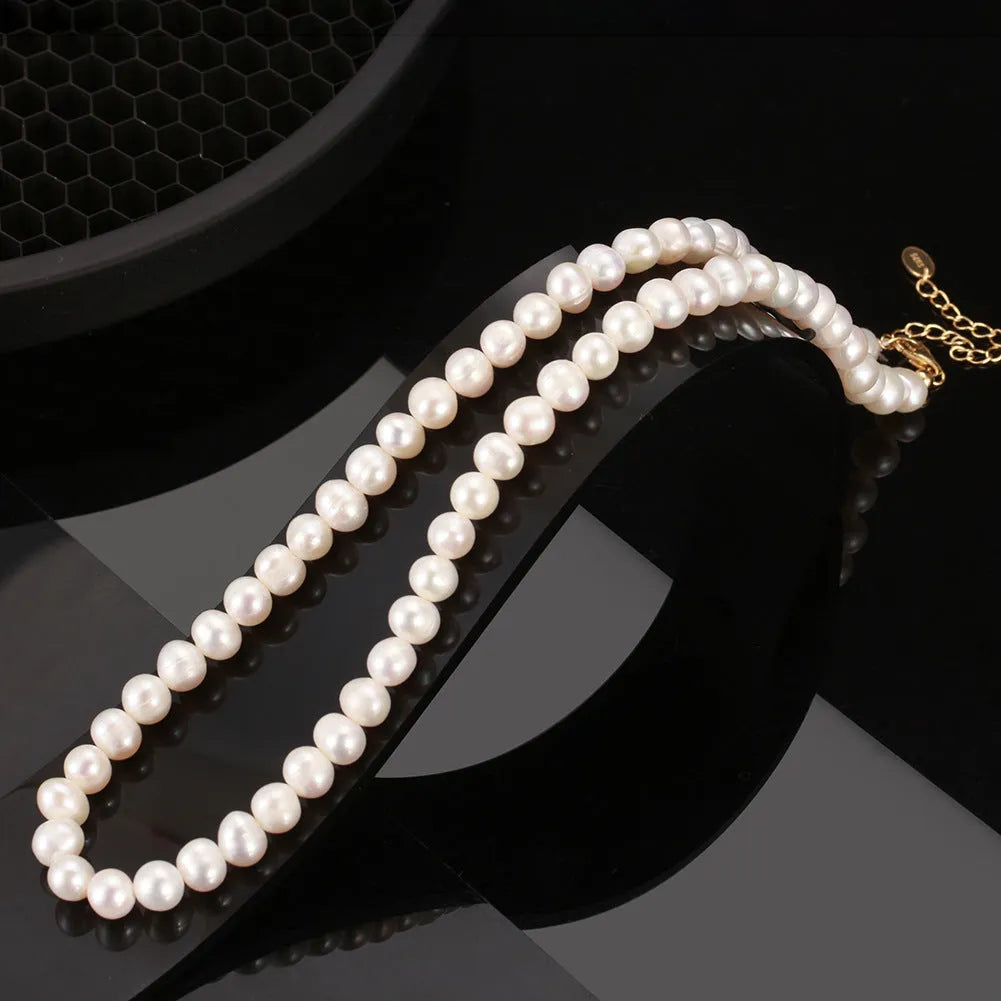 Women's silver necklace with a single round freshwater pearl and adjustable lobster clasp.