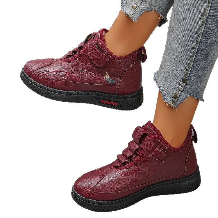 Women's black velvet house shoes with non-slip rubber sole and low tube socks design.