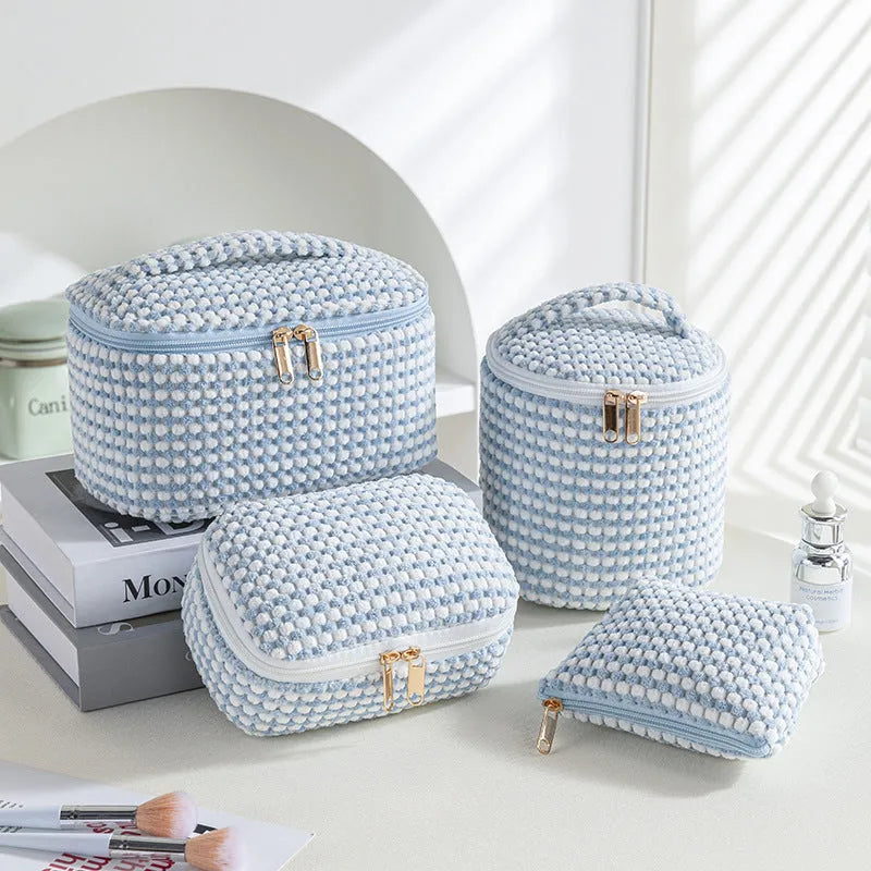 Four cube-style flannelette makeup bags in a set, shown in a blue with dots colour theme.