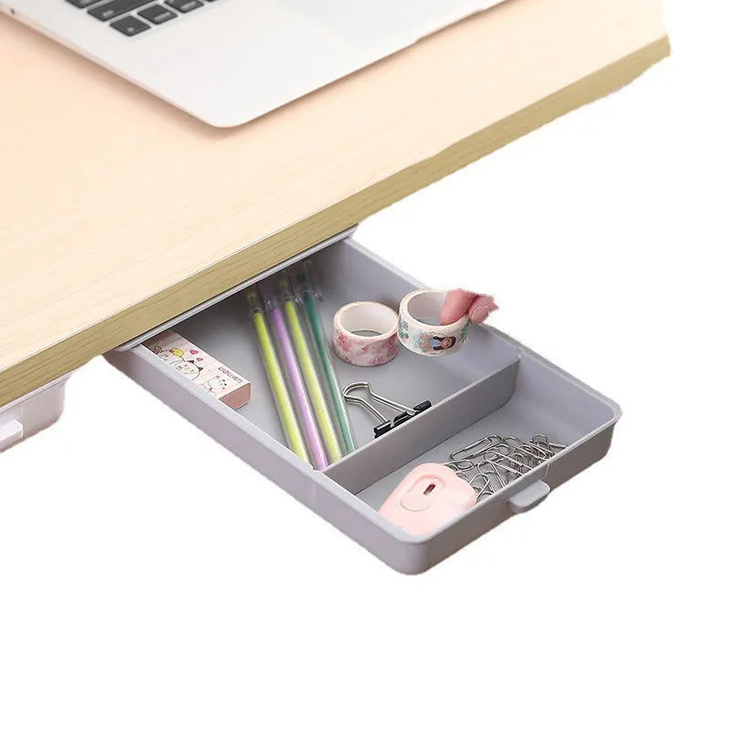 White plastic storage drawer with a cover and internal grid compartments, shown mounted underneath a wooden table.