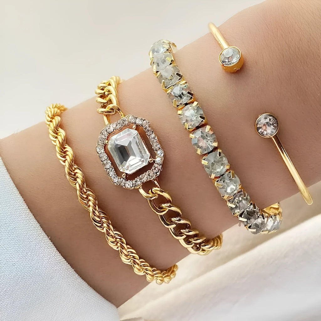 Gold and silver alloy square diamond geometric jewellery set with bracelet and pendant on a white background.