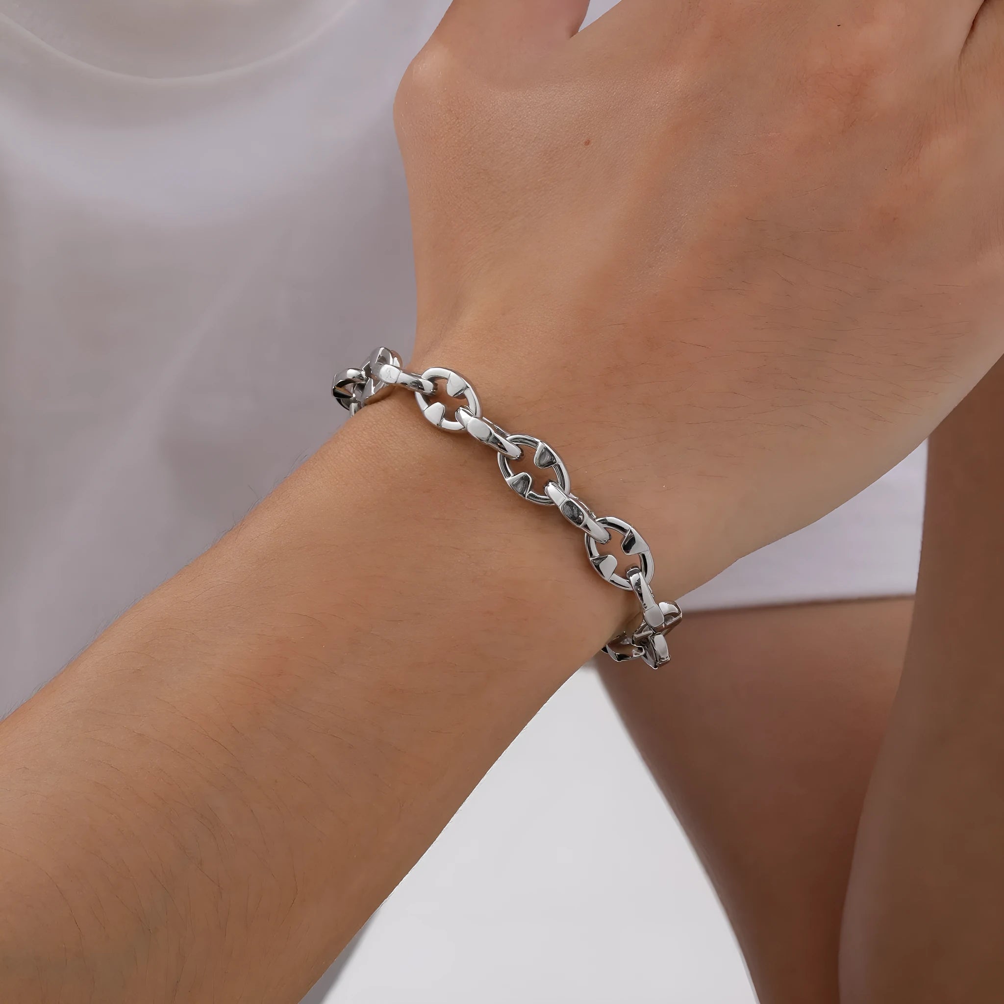 A thick handmade stainless steel bracelet with a geometric shape and steel colour finish.