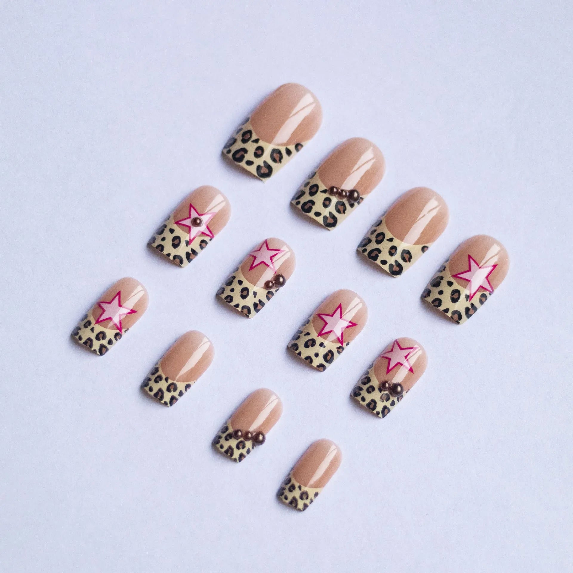French style leopard print nail art strips with pearl and five-pointed star decorations for manicures.