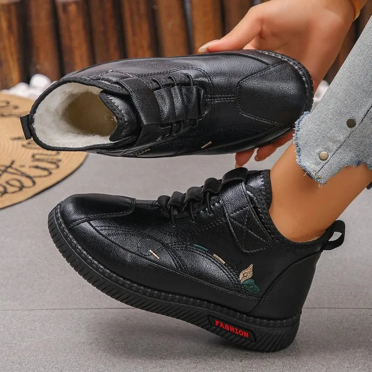 Women's black velvet house shoes with non-slip rubber sole and low tube socks design.