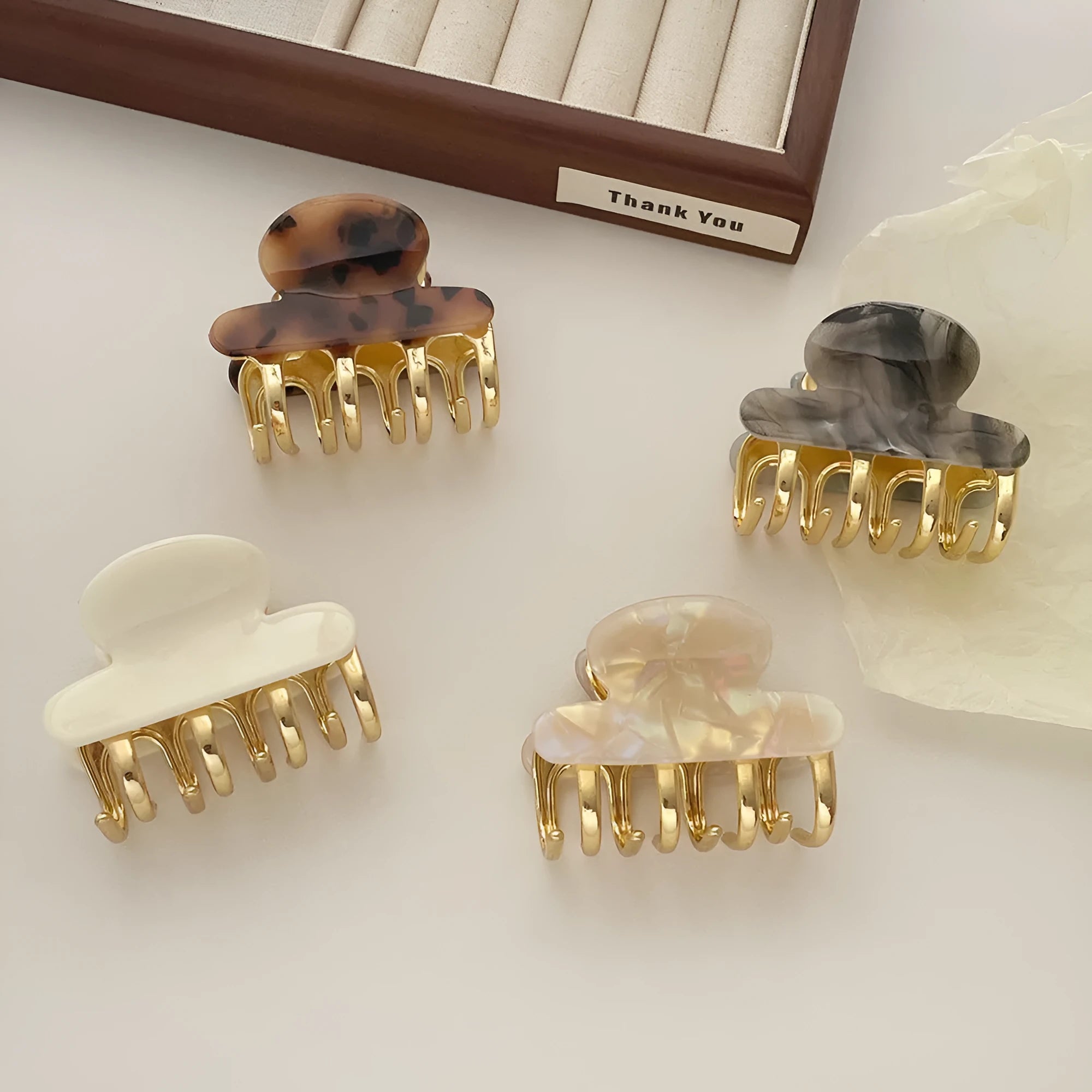 Women's hair barrettes with metal grip in alloy acrylic showing four colour options