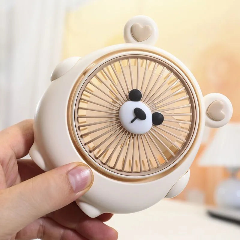 Small plastic desktop fan with a cute dog design, showing USB port and control buttons.