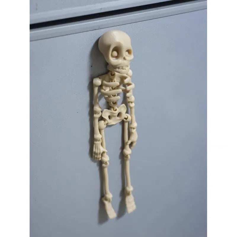 3D printed white skull refrigerator magnet with intricate details on a metallic surface.