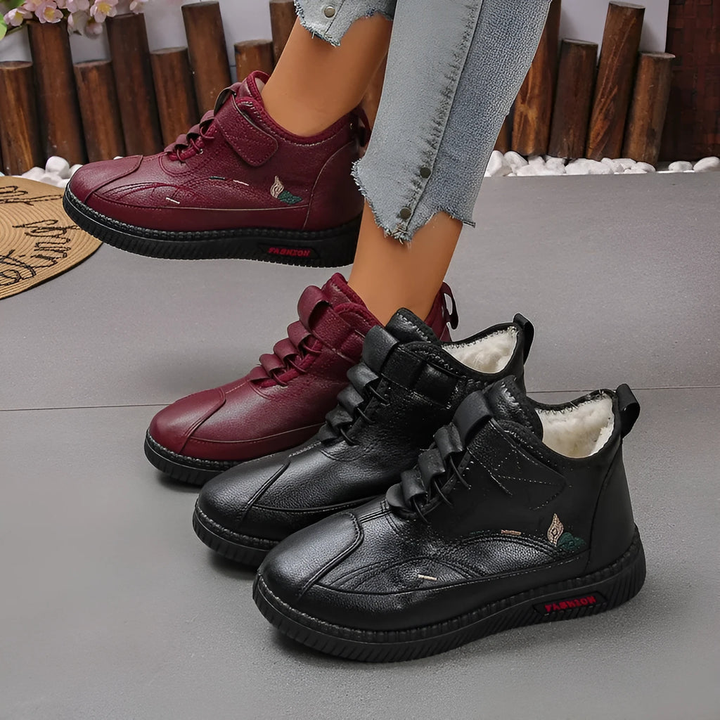 Women's black velvet house shoes with non-slip rubber sole and low tube socks design.