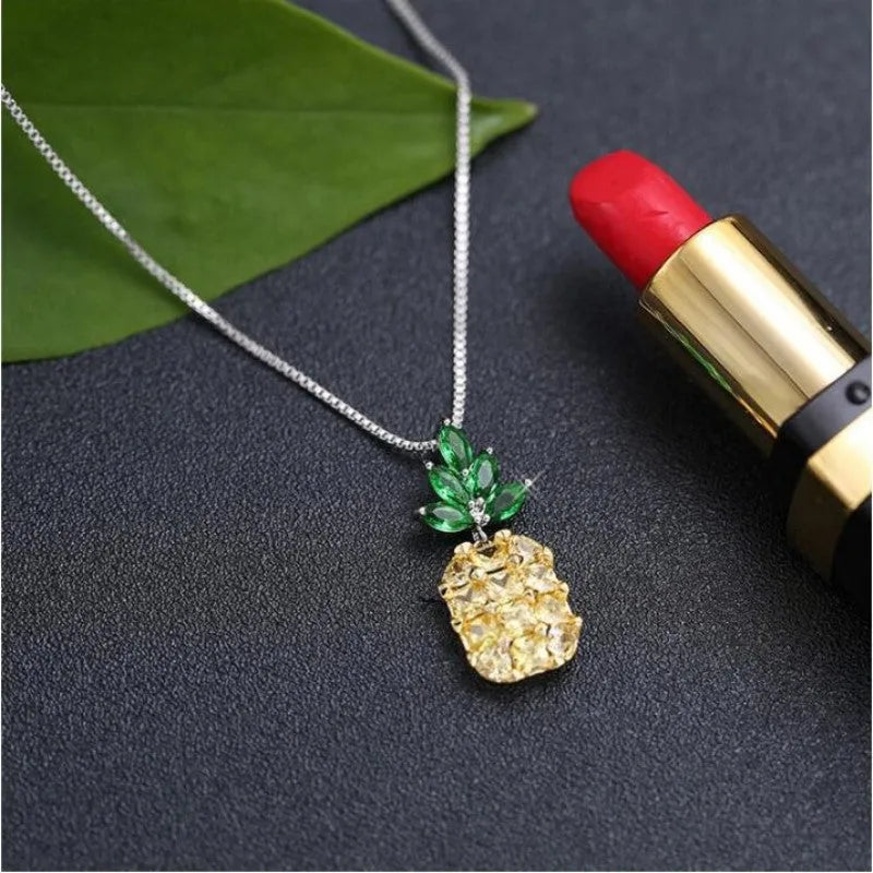 Silver geometric women's necklace with a pineapple and diamond motif pendant.