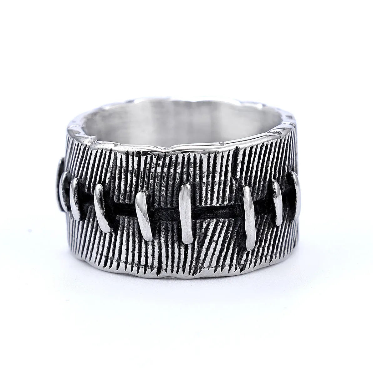 A dark geometric titanium steel ring with punk stitching and a double ring design on a grey background.