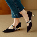 Women's black stiletto heels with buckle fastening and pointed toe design