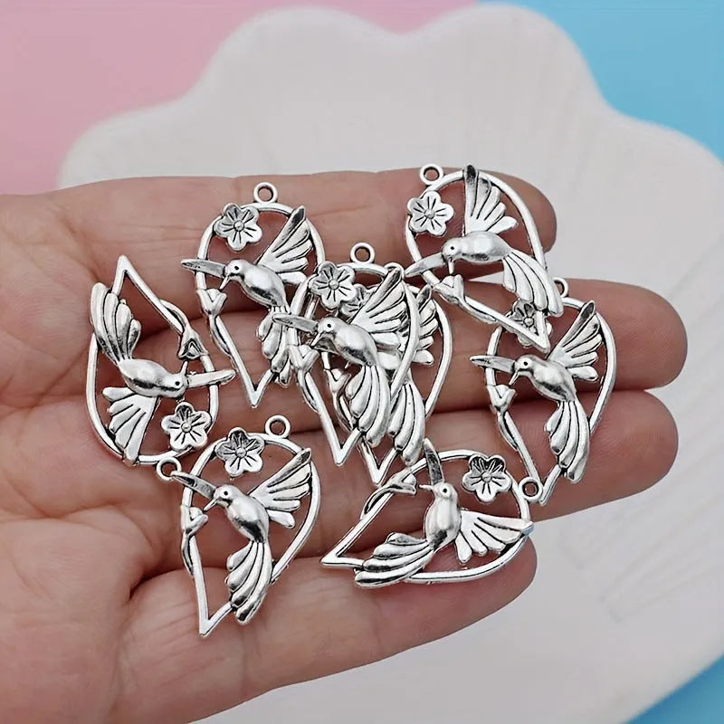 Gold-tone alloy magpie pendant charm for DIY jewellery making on a white background.
