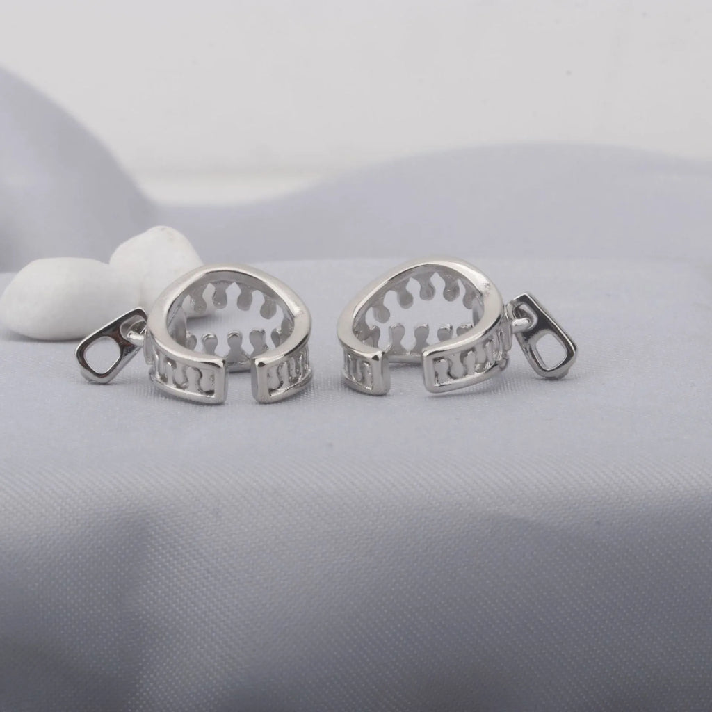 A pair of simple geometric copper clip-on earrings in colour ES862 with a linear pattern design.
