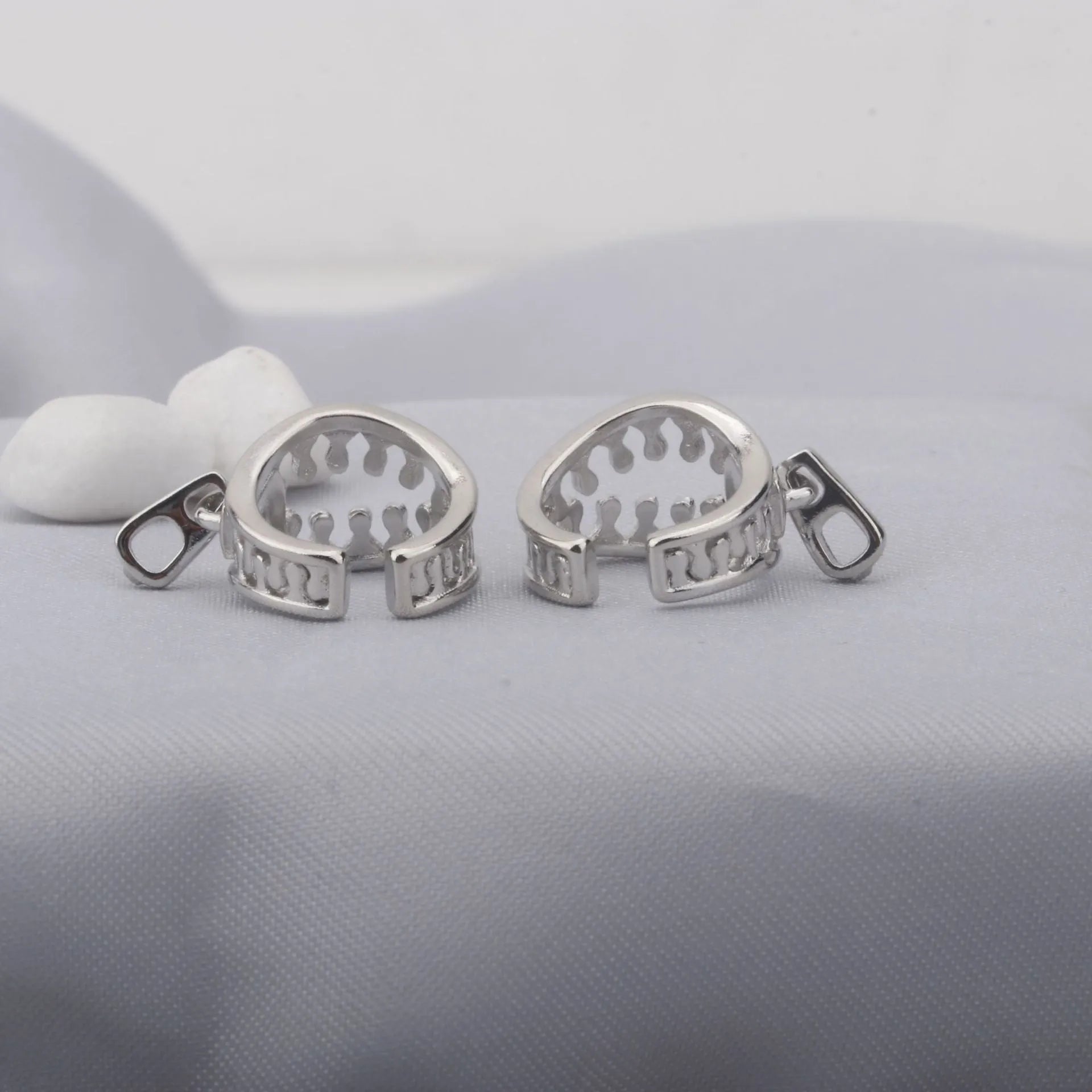 A pair of simple geometric copper clip-on earrings in colour ES862 with a linear pattern design.