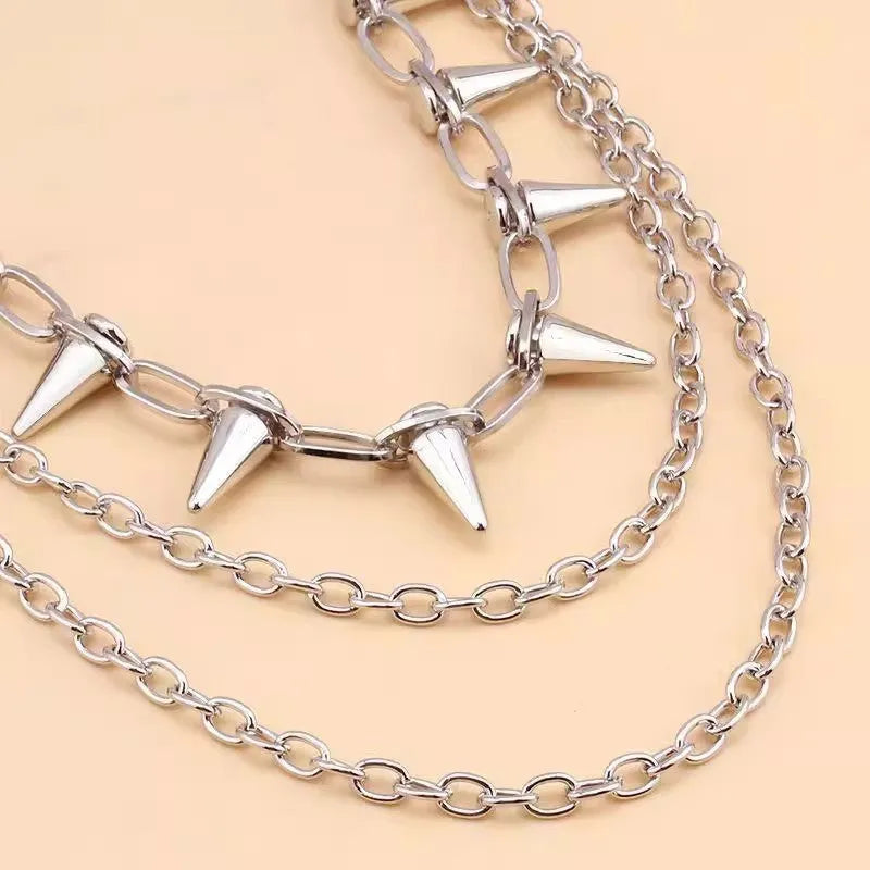 Silver metal waist chain with punk rivet decoration and zipper fastening, showing double layered construction