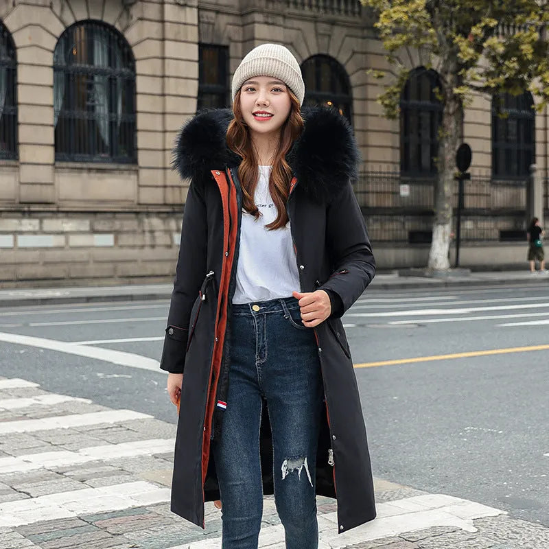 Women's long beige fleece trench coat with two-way zip, shown on a model.