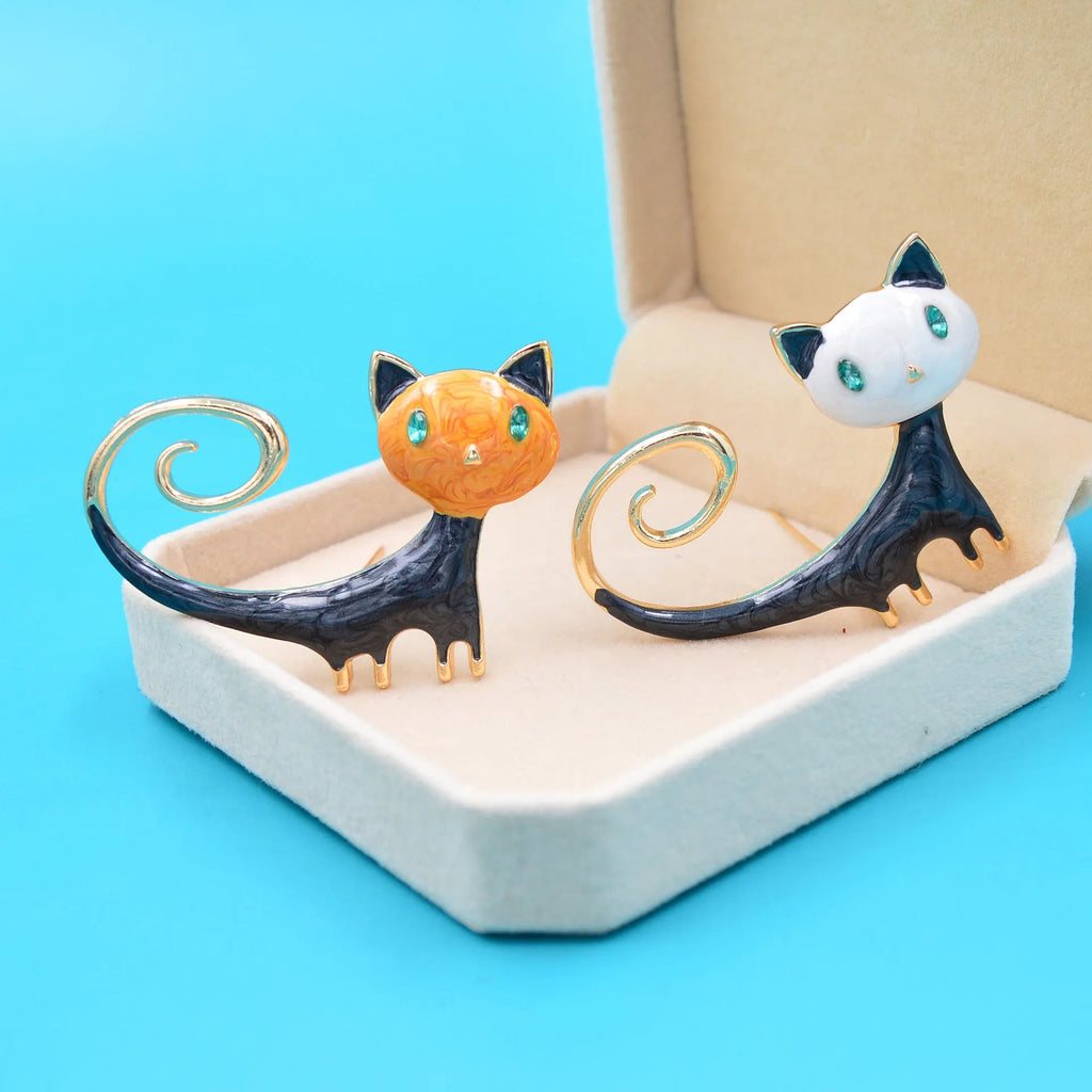 White or orange kitty cat brooch with painted upward tail design on alloy metal