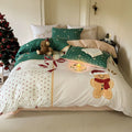 Christmas cartoon character bedding set with duvet cover, fitted sheet and pillowcases laid on a bed