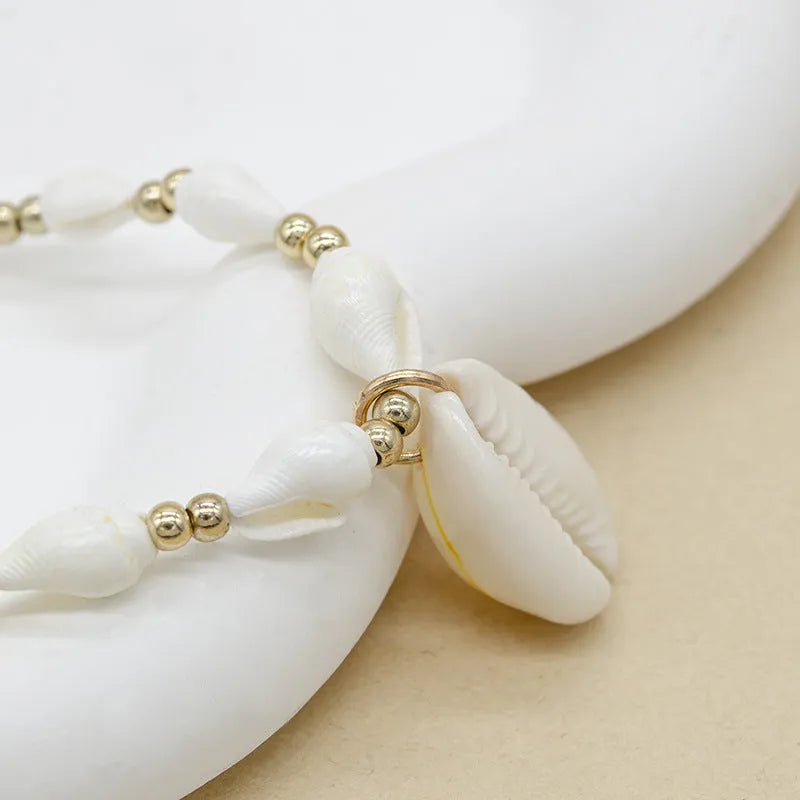 White conch shell necklace with mother-of-pearl pendant on electroplated chain with bead accents