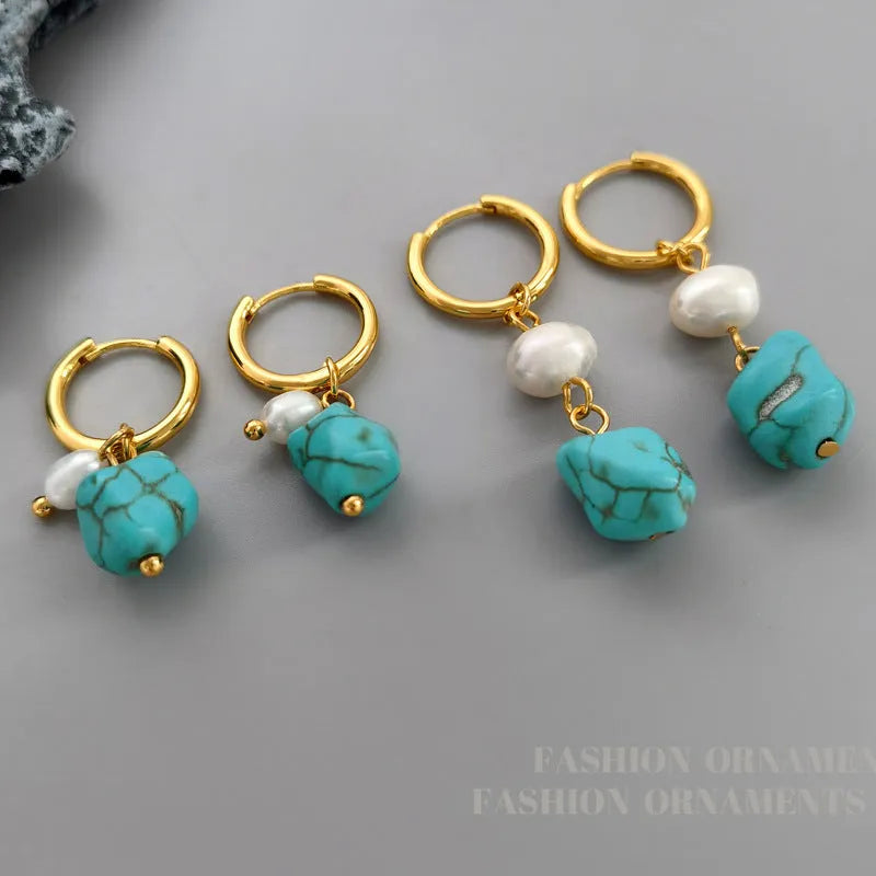 A set of two pairs of women's ear clips: one short and one dangle style, with geometric copper design, turquoise, and cultured pearls.
