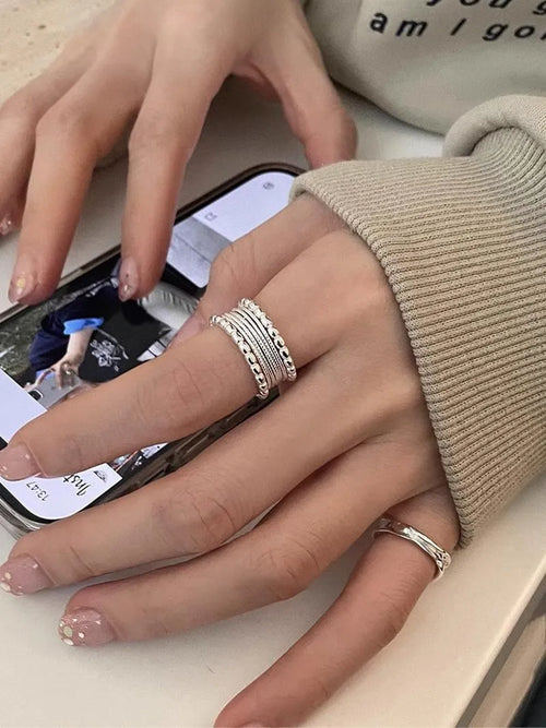 Adjustable geometric ring with woven twisted copper alloy construction