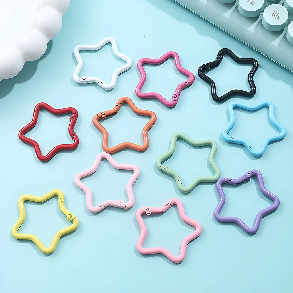Zinc alloy five-pointed star keychain charm in multiple colour options on a white background.